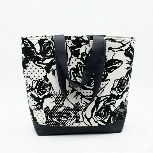 Bolsa Tote Rosas Noir | Encantos en tonos blanco y negro con diseño de rosas y puntos, asas negras y base reforzada, ideal para uso diario.