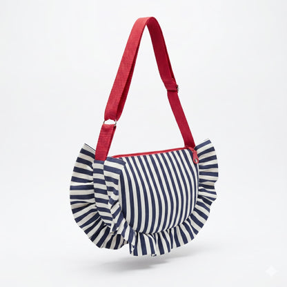 Bolso artesanal HALF MOON de Encantos, silueta media luna con volante perimetral en tela de rayas azul marino y blanco, asa larga regulable en rojo coral y cremallera roja

