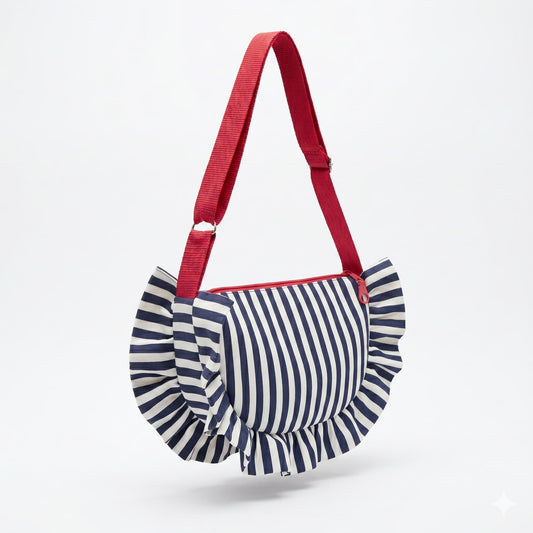 Bolso artesanal HALF MOON de Encantos, silueta media luna con volante perimetral en tela de rayas azul marino y blanco, asa larga regulable en rojo coral y cremallera roja

