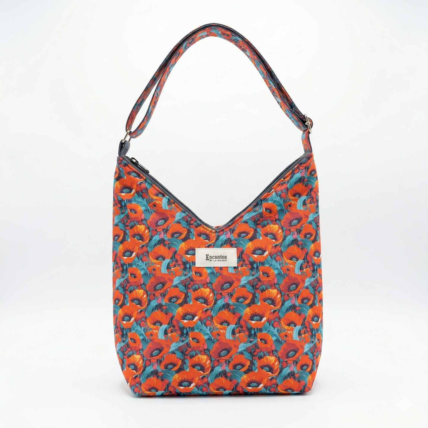 Bolso Hobo Amapolas | Encantos con diseño floral en tonos naranjas y azules, con asa única y cierre superior, ideal para un estilo casual y moderno.