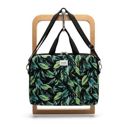 Bolso laptop hojas tropicales verde negro - vista frontal colgado